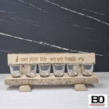 Small benches with shot glasses, various sayings